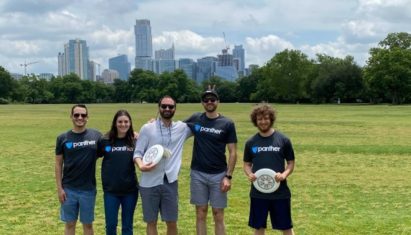 Panther employees with frisbees at a park